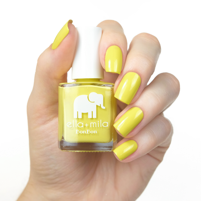 Limoncello vibrant yellow nail polish manicure on a light skin tone with the bottle