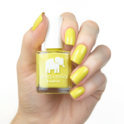 Limoncello vibrant yellow nail polish manicure on a light skin tone with the bottle
