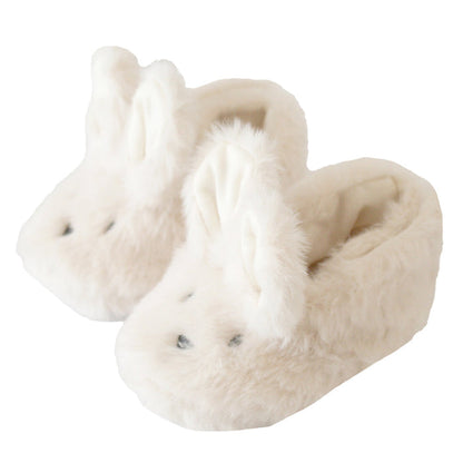 Ivory plush bunny slippers, front view with stitched eyes and nose, soft padded lining
