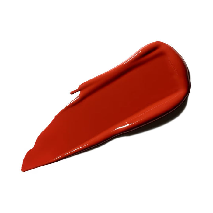 MAC LustreGlass Lipstick in Chili Popper shade, featuring a glossy finish and vibrant red color, displayed in the image.