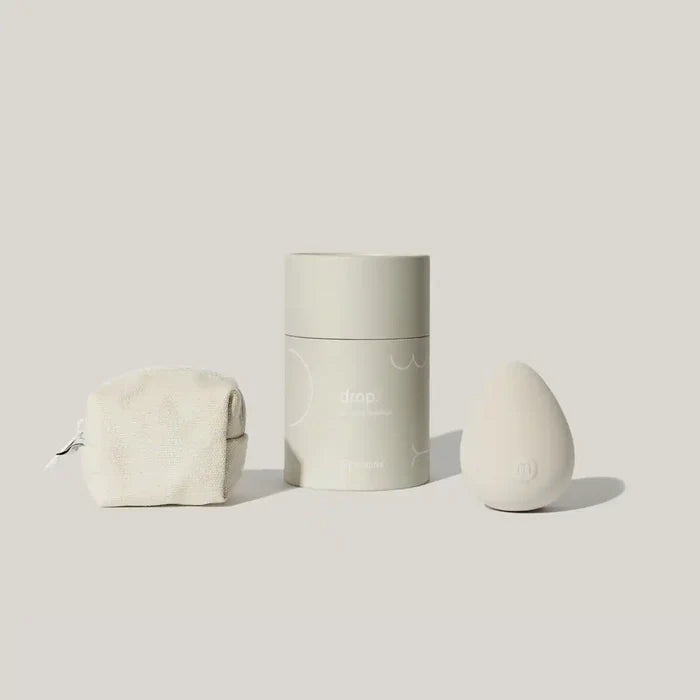 Maude Drop Body Massager, a sleek pleasure device with smooth design, shown in a modern, minimalist setting.