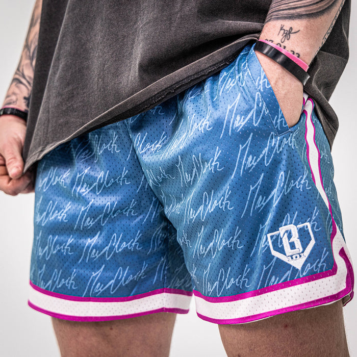 Adult model wearing shorts with “Max Clark Signature” design