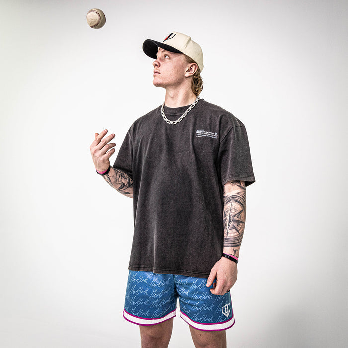 Adult model wearing shorts with “Max Clark Signature” design