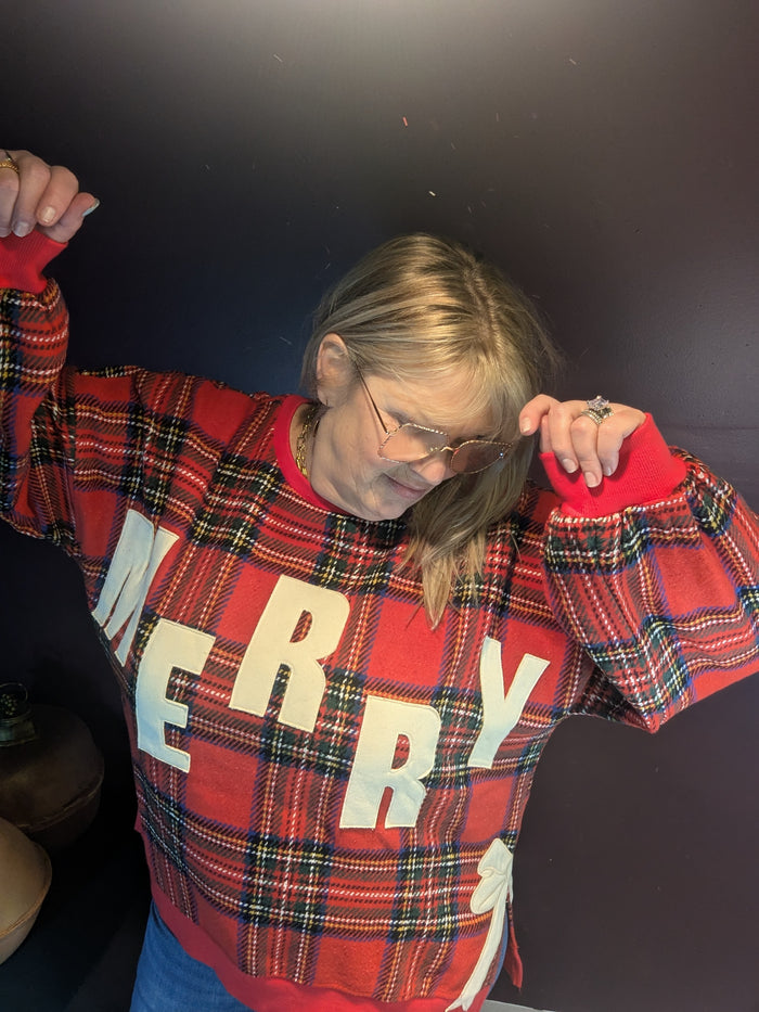 BiBi Merry Bow sweatshirt featuring a festive design with a large bow graphic on a cozy, casual sweatshirt.