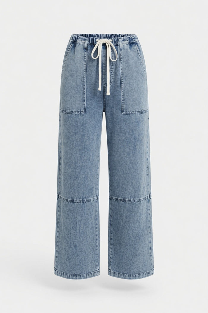 Light blue wide-leg denim pants with a drawstring waist and front patch pockets, shown on a plain light gray background.