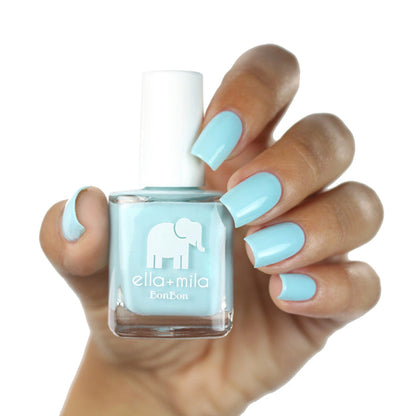 My Baby Blue nail polish on a medium skin tone, hand holding the bottle