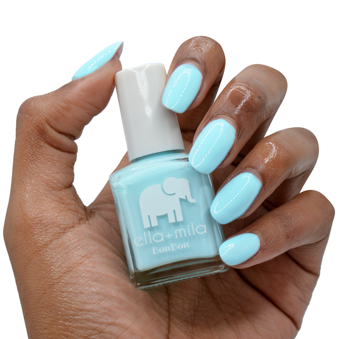 My Baby Blue nail polish on a deep skin tone, hand holding the bottle