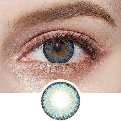 Close-up of an eye wearing NEO Vision Cosmo Blue contact lenses by NEO Vision, featuring a blue and green pattern around the iris. A circular image below shows the intricate design of these cosmetic lenses.