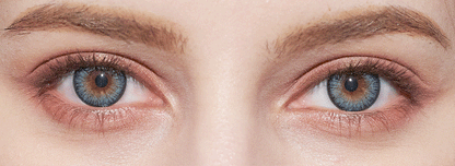 Close-up of a face showcases both eyes—one blue, one brown—with well-groomed eyebrows and natural skin texture, highlighting the striking effect of NEO Vision Cosmo Blue coloured contact lenses from NEO Vision.