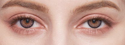 Close-up of a person's face highlighting their hazel eyes, well-groomed eyebrows, and natural makeup, enhanced by NEO Vision Cosmo Violet coloured contact lenses from NEO Vision.