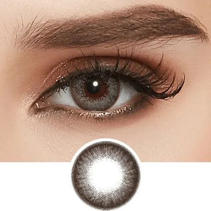 A close-up shows an eye with long lashes, brown eyeshadow, and the NEO Vision Extra Dali Grey contact lens by NEO Vision; below is a separate image of this grey circle lens.