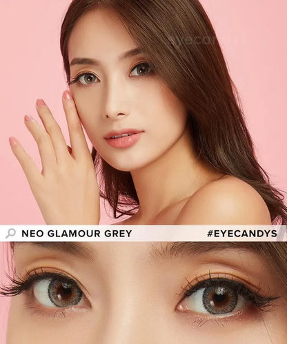 A woman with long brown hair poses against a pink background, highlighting her brown eyes wearing NEO Vision Glamour Grey (Custom Toric for Astigmatism) contacts by NEO Vision. Text reads "NEO VISION GLAMOUR GREY #EYECANDYS.