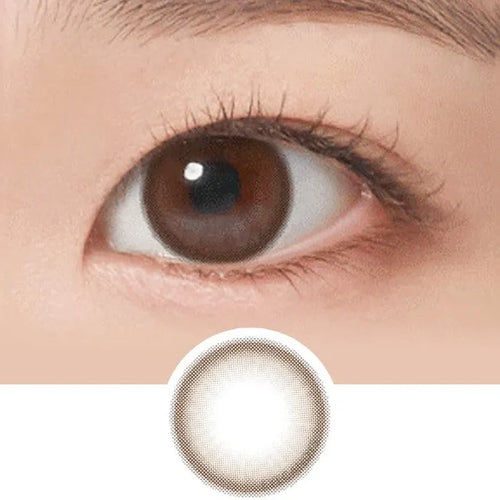 Close-up of a brown eye with NEO Vision Neoism Dali Choco 1-Day (50pk) contacts. These daily disposables from NEO Vision feature a subtle brown tint and gradient pattern for a fresh, natural look.