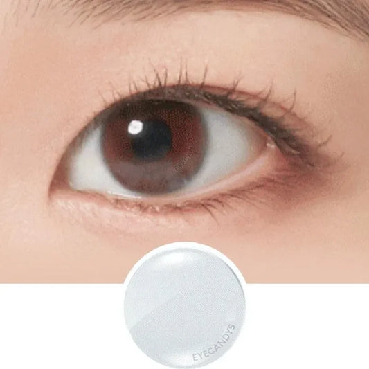 A close-up of a natural brown eye above an image of a single NEO Vision Neoism Super Clear (50pk) contact lens by NEO Vision on a white background.