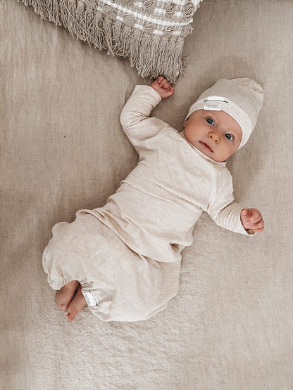 Eco-friendly kids' clothing – gender-neutral heather cream newborn gown, sustainably made in Canada.