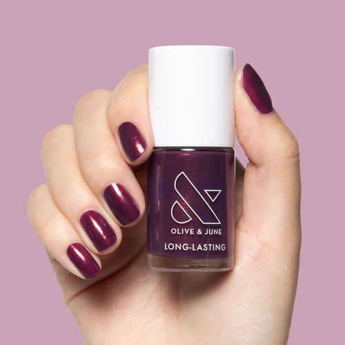 On the Promenade nail polish on hand with shimmering mulberry purple for a long-lasting at-home manicure