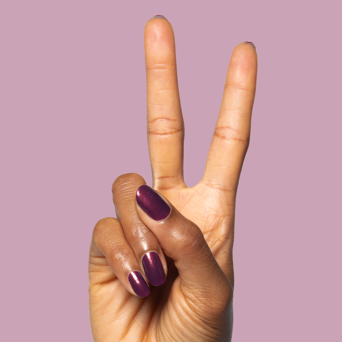 On the Promenade shimmering mulberry purple gel polish on nails for a stylish and long-lasting at-home mani