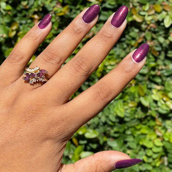 On the Promenade gel polish on nails showing shimmering mulberry purple for a vibrant at-home manicure look