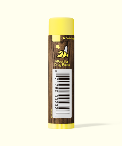 Lip balm with a yellow cap and brown body on a white background