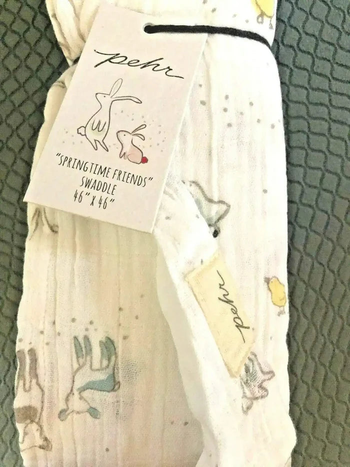 Pehr Springtime Friends baby swaddle blanket, 46x46 inches, featuring colorful spring-themed patterns on soft fabric.