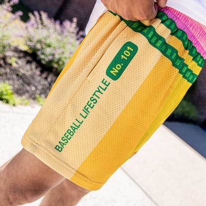 Youth model wearing yellow youth shorts with “Pencil” design