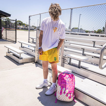 Youth model wearing yellow youth shorts with “Pencil” design
