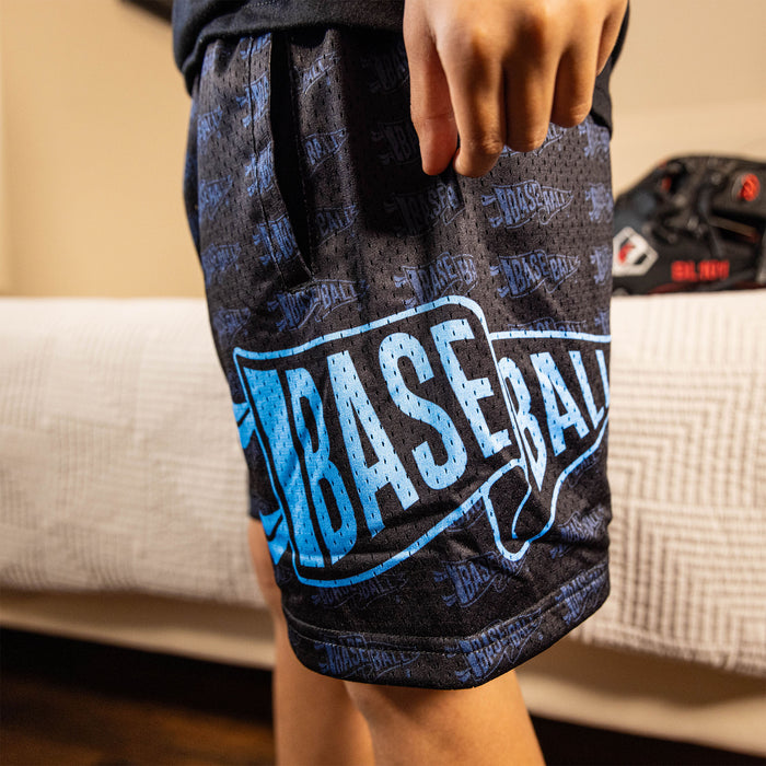 Youth model wearing black and light blue Pennant youth shorts
