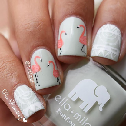 Pistache pastel green nail polish with pink flamingo nail art accents