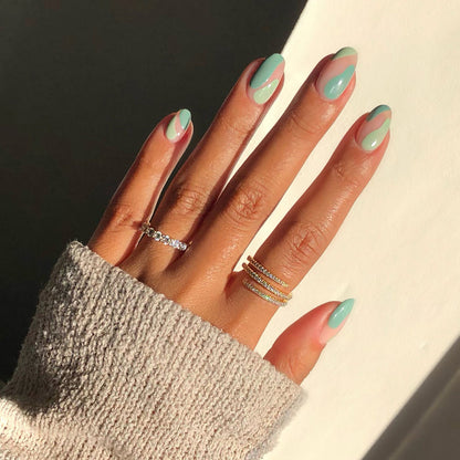 Pistache mint green nail polish manicure with rings and a cozy knit sweater