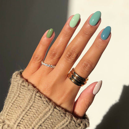 Pistache pastel green nail polish manicure with mixed pastel accent nails