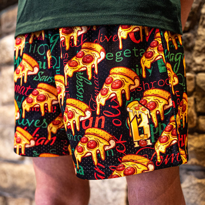 Youth model wearing multi-color youth shorts with “Pizza” design