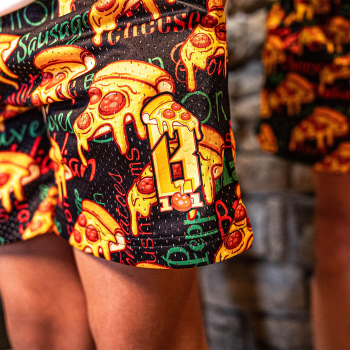 Youth model wearing multi-color youth shorts with “Pizza” design