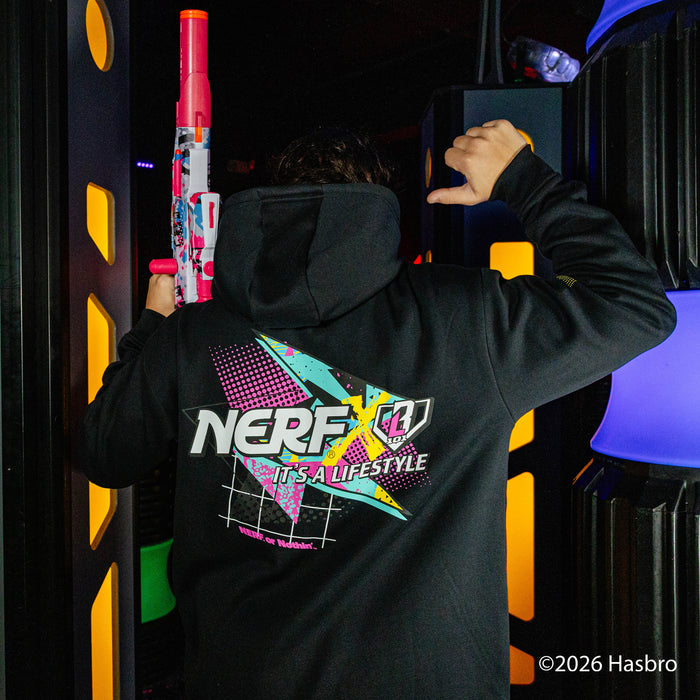 Person wearing a black hoodie with a colorful 'NERF It's a Lifestyle' logo, holding toy guns in a dark setting.