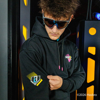 Person wearing a black hoodie with NERF X BL101 logos, standing in front of a dark background with yellow accents.