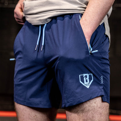 Youth model wearing navy and light blue Pro Series with Liner youth shorts