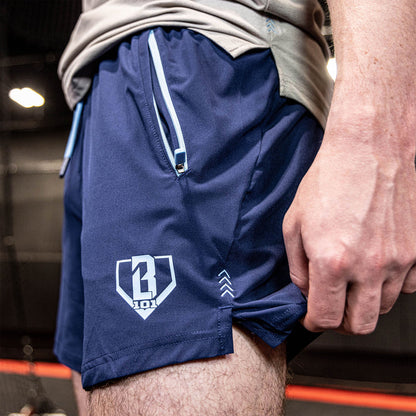 Youth model wearing navy and light blue Pro Series with Liner youth shorts