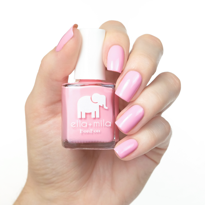 Pucker Up bubblegum pink nail polish manicure on a light skin tone with the bottle