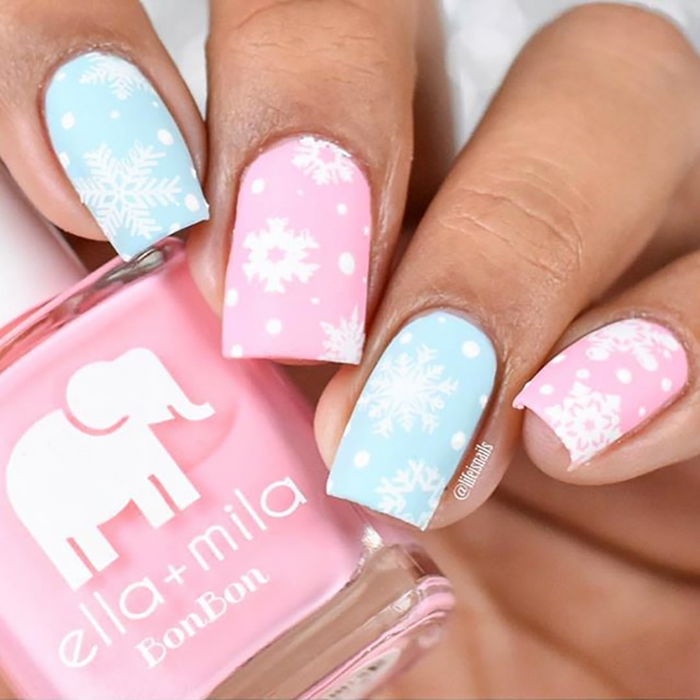 Pucker Up pink nail polish with blue and white snowflake accent nail art
