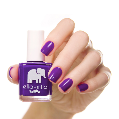 Purple Reign deep purple nail polish manicure on a light skin tone with the bottle