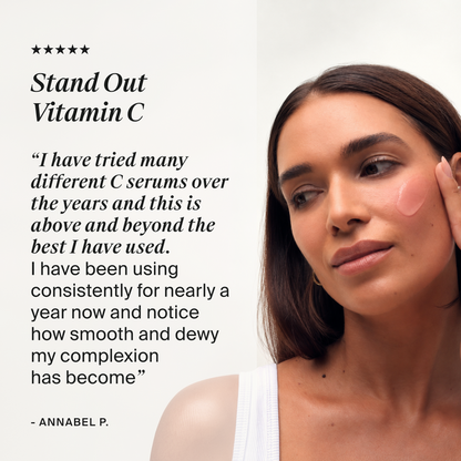 A promotional skincare graphic with a close-up of a woman applying or showing a pink vitamin C cream on her cheek, next to a large quote that reads 'Stand Out Vitamin C' and a testimonial from 'Annabel P.'.