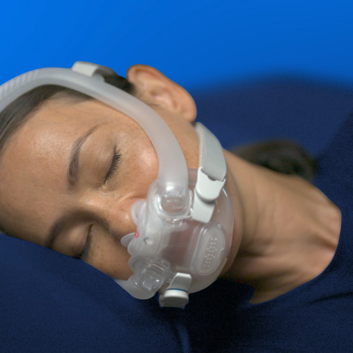 Woman sleeping soundly wearing the AirFit X30i oral nasal mask