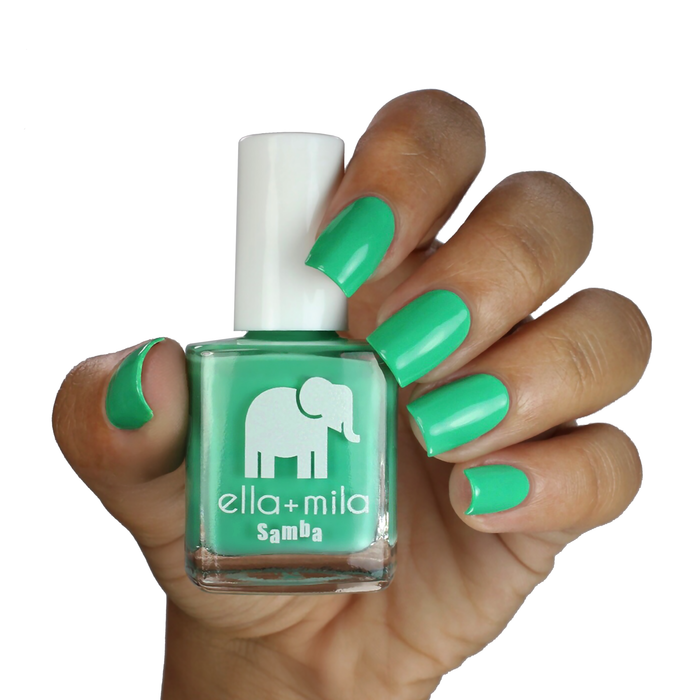Samba Beats bright green nail polish on a medium-deep skin tone, hand holding the bottle