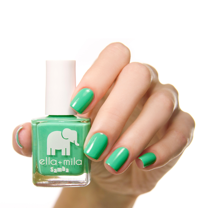 Samba Beats green nail polish manicure on a light skin tone with the bottle