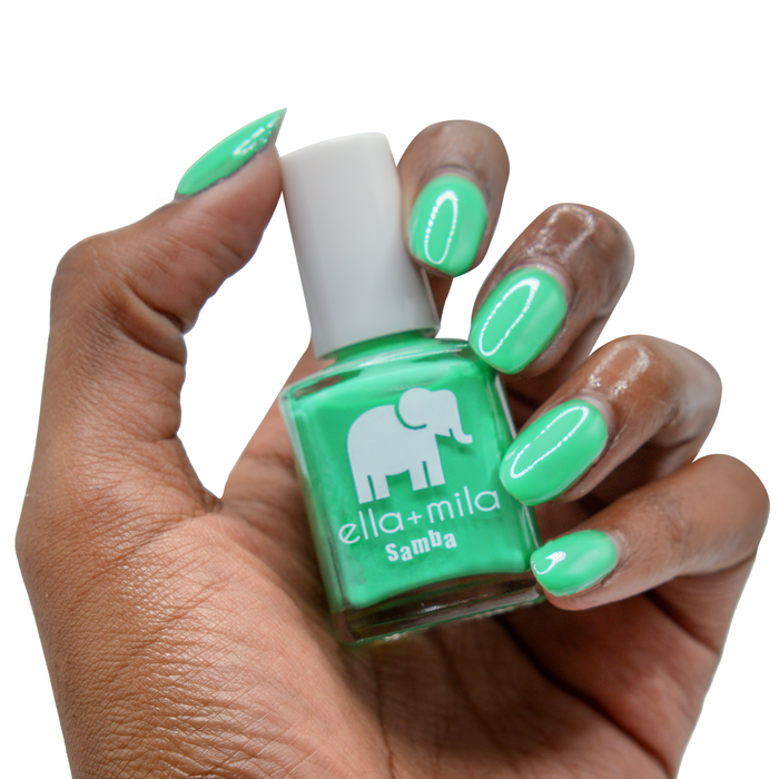 Samba Beats bright green nail polish on a deep skin tone, hand holding the bottle