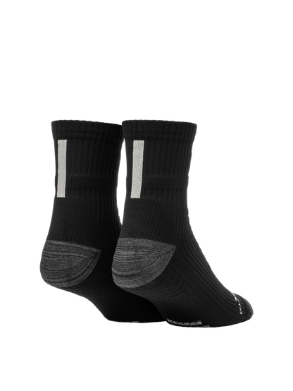 Rear three-quarter view of Selkirk Courtlock pickleball sock showcasing black crew length, gray cushioned heel, and white vertical tab on white background