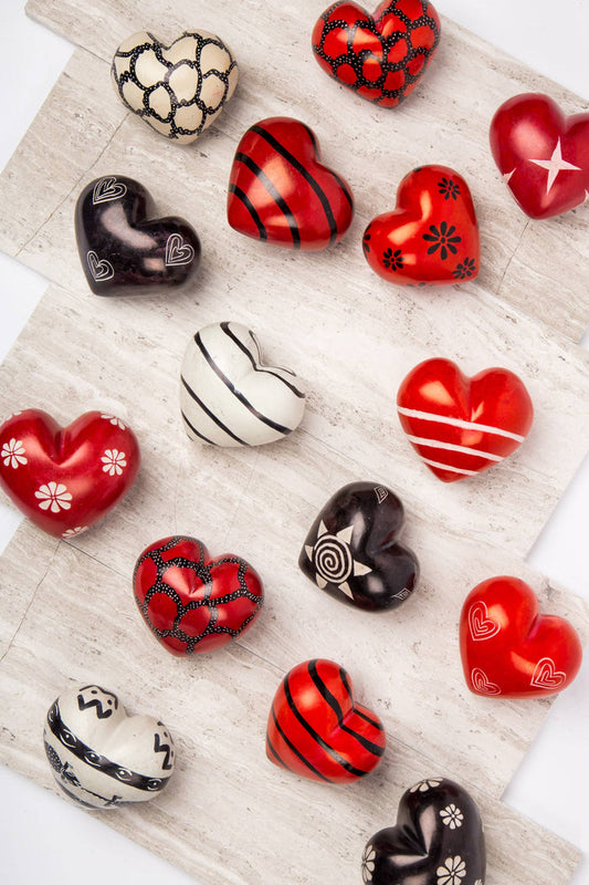 Colorful Share the Love Paperweight by Ten Thousand Villages featuring a 3D heart design on a clear base.