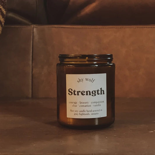 Shy Wolf Candles Strength home candle with chai, cinnamon, and vanilla scent in a glass jar, warm and inviting design.