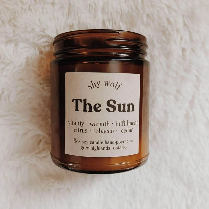 Shy Wolf Candles The Sun soy candle with citrus, tobacco, and cedar scents in a home decor setting.