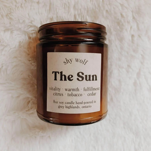 Shy Wolf Candles The Sun soy candle with citrus, tobacco, and cedar scents in a home decor setting.