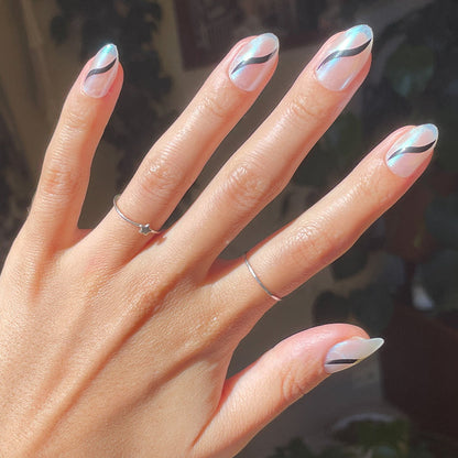Simple Twist - Press-On | Medium | Almond neutral press-on nails with sleek black swirl design on natural hand indoors